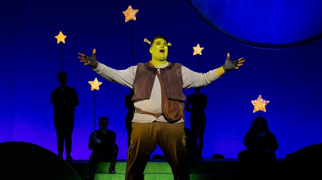 man dressed as a green ogre on stage
