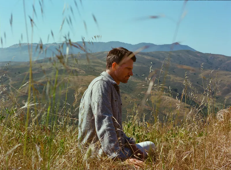 Image: man sitting in a field