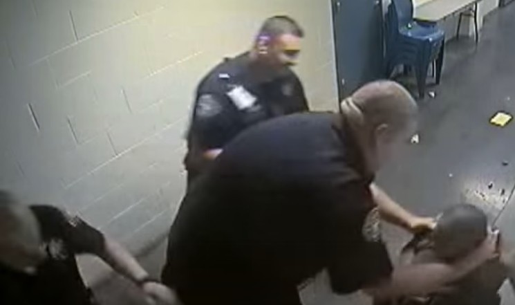 A deputy takes hold of Michael Marshall near the beginning of the incident that led to the inmate's death. - DENVER 7 VIA YOUTUBE
