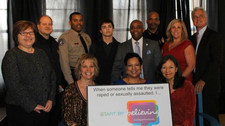 Mayor Michael Hancock (back row, fourth from right) and other officials and advocates at the 2015 launch of the Start by Believing campaign. - CITY OF DENVER VIA CBS4