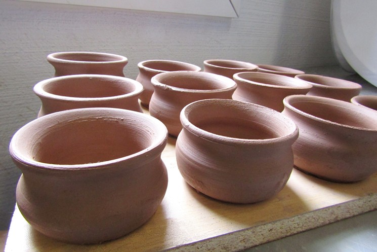 Clay cups await glazing and firing before being delivered to Cochino Taco. - MARK ANTONATION