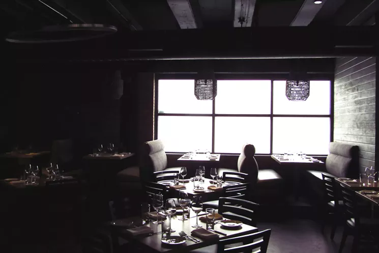 Ad Hominem's dining room gets a burst of brightness from a frosted window on the east side of the building. - MARK ANTONATION