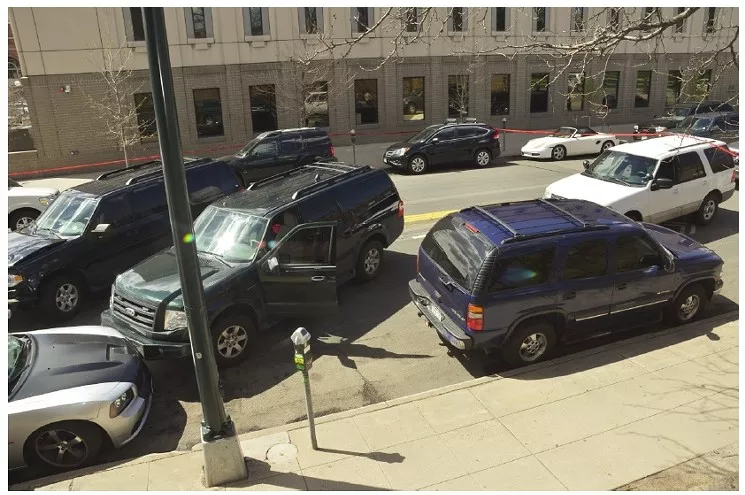This photo shows how members of the Rocky Mountain Safe Streets Task Force pinned Dion Damon's car against a curb. - DENVER DISTRICT ATTORNEY'S OFFICE