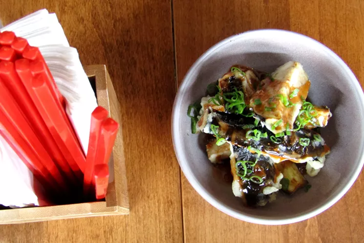 Fried Chinese eggplant with General Tso's sauce — one of very few nods to American Chinese cuisine. - MARK ANTONATION