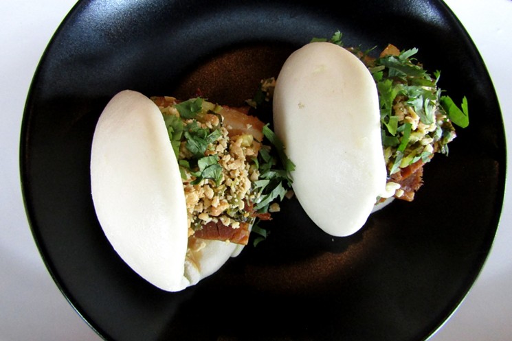 Pork-belly buns with pickled mustard greens, peanuts and cilantro. - MARK ANTONATION