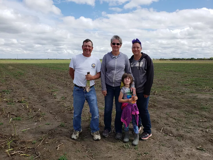 Kiowa Valley Organics is a family farm owned by David Rippe and his wife, Sara Bevan (center). Bevan's daughter, Krista Peace, also helps, along with her five-year-old, Allison. - LINNEA COVINGTON