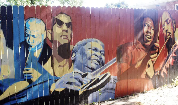On a cedar fence in Englewood, the blues great B.B. King grooves on Lucille. He is joined on the left by Sidney Bechet and Sonny Rollins – the only living artist depicted on the wall. On the right are drummer Elwin Jones and flutist Eric Dolphy. - AMANDA PAMPURO