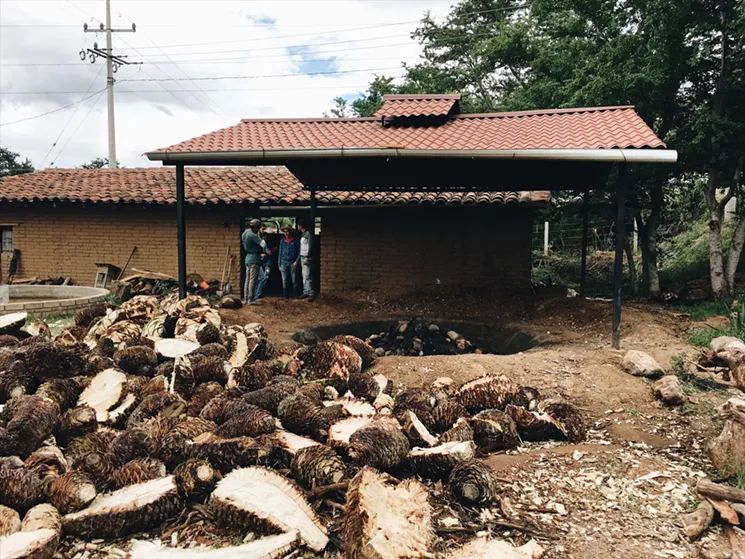 The Bahnez team waits for the fire to reach the right temperature and then adds the piñas. - LAURA SHUNK