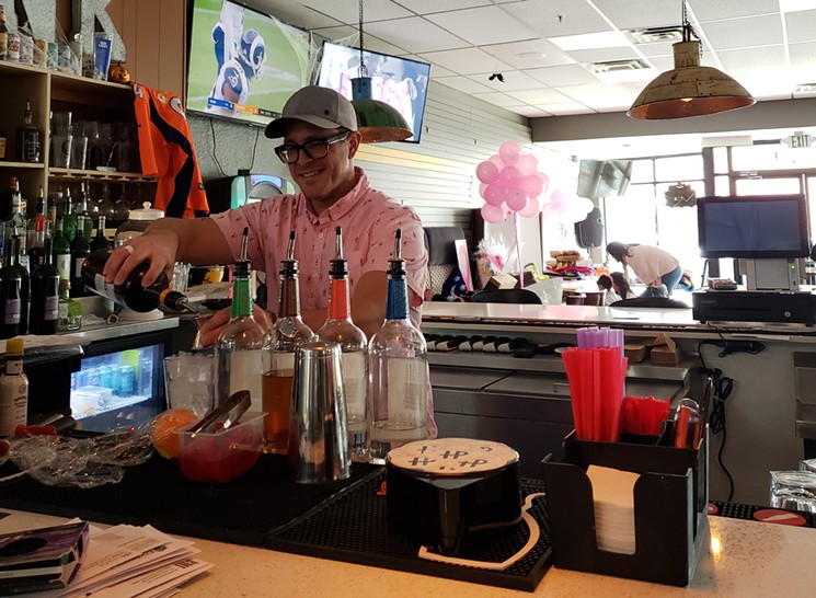 Owner Brian Meadows mixes up drinks behind the bar on a Sunday at Duffer Haus. - SAMANTHA MORSE