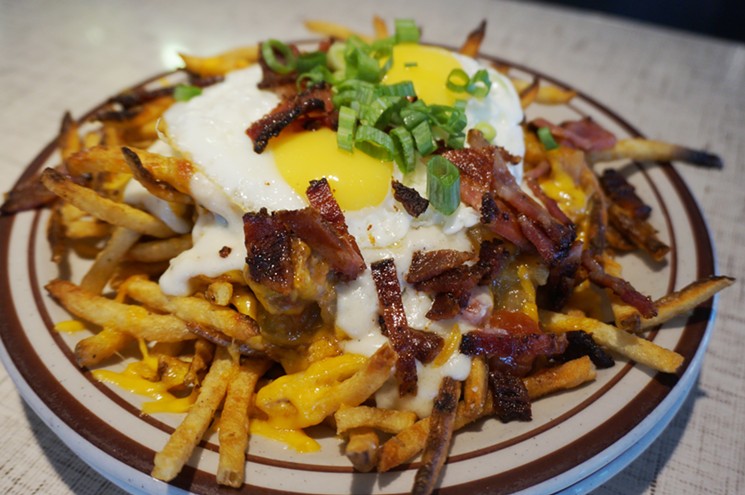 Get the Traffic Jam — fries, green chile, gravy, eggs and bacon — at Steuben's Arvada as it celebrates its first anniversary. - MARK ANTONATION