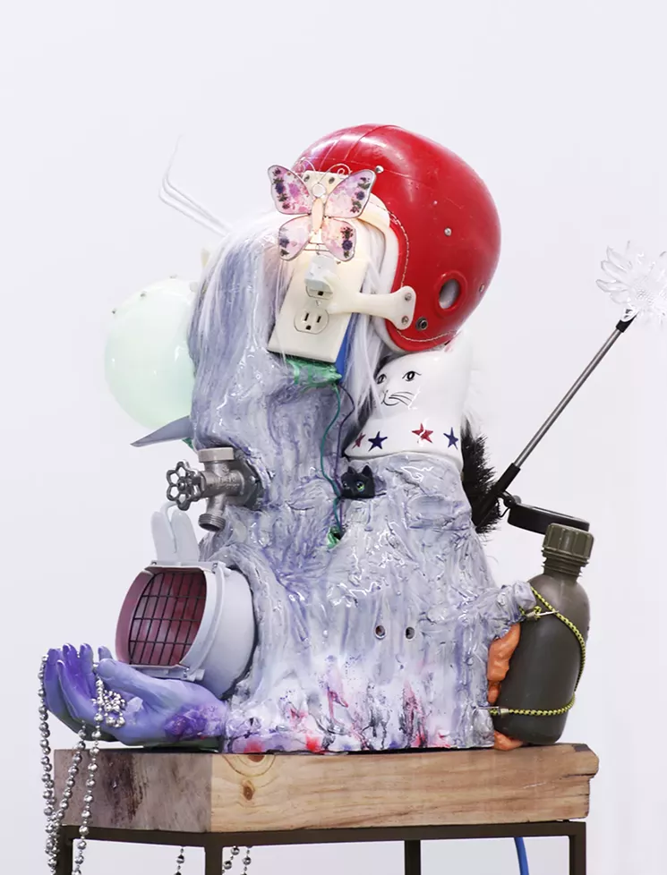 Donald Fodness, "Yard Hero (From the Man with the Golden Arm)." 2017, ceramic, wood, metal, glass, foam, glue, electric outlet, electric wire, three prong plug, lamp, fan, butterfly, night light, yard light, faucet, canteen, helmet, wig, garden rake, shovel, hoe, hand broom, cookie jar lid, mannequin hands, beaded necklaces, bungee chords, hooks, my lil pet shop heads, spray paint, acrylic paint, ink, glow in the dark plastic. - COURTESY OF DONALD FODNESS