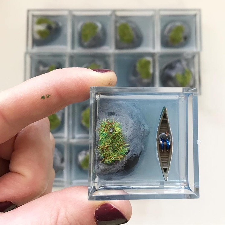 A limited-run lonely island diorama enclosed under a magnifying lid by Miniatures for a Modern World. - MINIATURES FOR A MODERN WORLD
