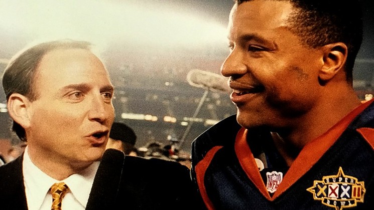 Les Shapiro interviewing Denver Broncos legend Steve Atwater at Super Bowl XXXII. - COURTESY OF LES SHAPIRO