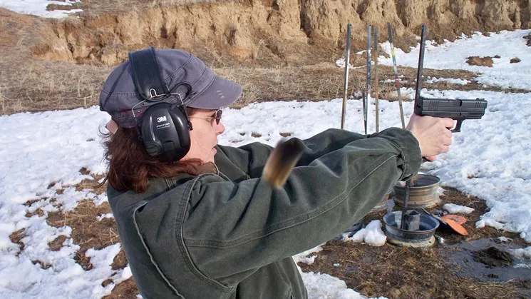 The caption on this 2012 Facebook photo of Representative Lori Saine squeezing off a round reads: "See that brown amorphous shape in the center of the photo? I had to post this because Phil Saner actually caught the casing flying towards the camera." - FACEBOOK