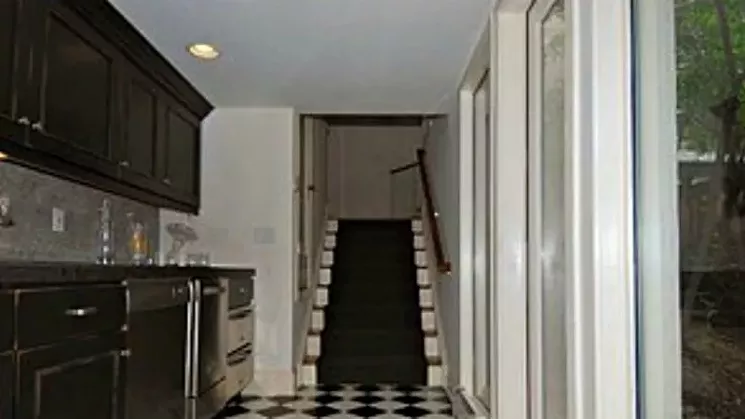 A staircase inside the home, as seen in a photo from the 2011 listing. - COURTESY OF CAROL SCHULLER MILNER