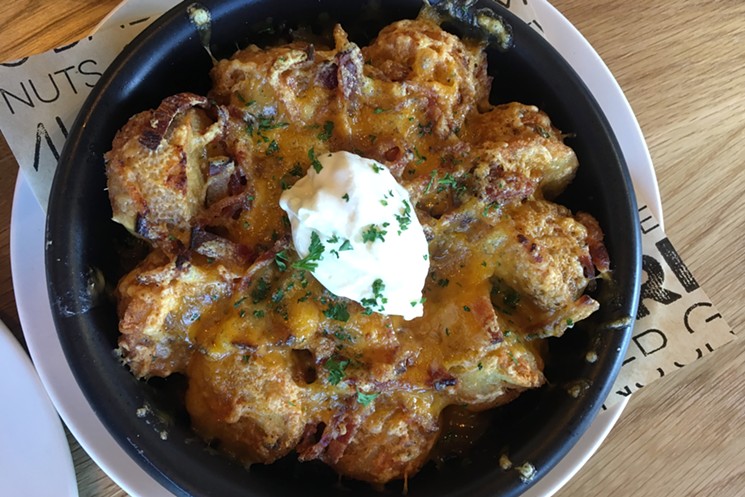 Loaded tater tots: bacon cheddar, chives, "mo'nay" sauce and sour cream. - MARK ANTONATION