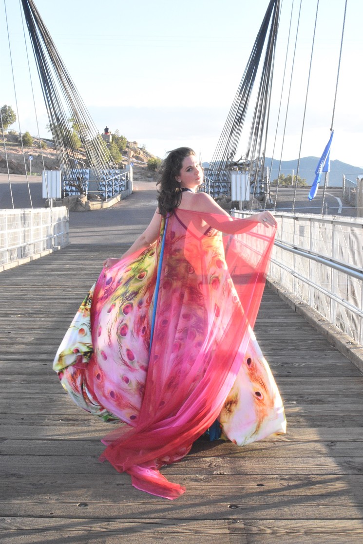 A model in a Mona Lucero gown walks an outdoor runway on the Royal Gorge Bridge. - COURTESY OF MONA LUCERO