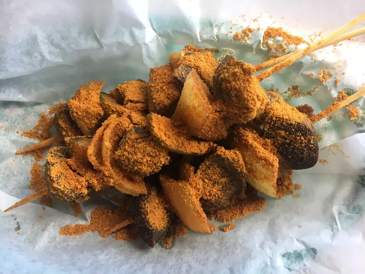 Turkey gizzard skewers are dusted in a mild spice blend that includes ground peanuts. - MARK ANTONATION