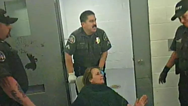 Carolyn O'Neal as she was being wheeled into a room where she was left while strapped to the restraint chair. - KILLMER, LANE & NEWMAN, LLP