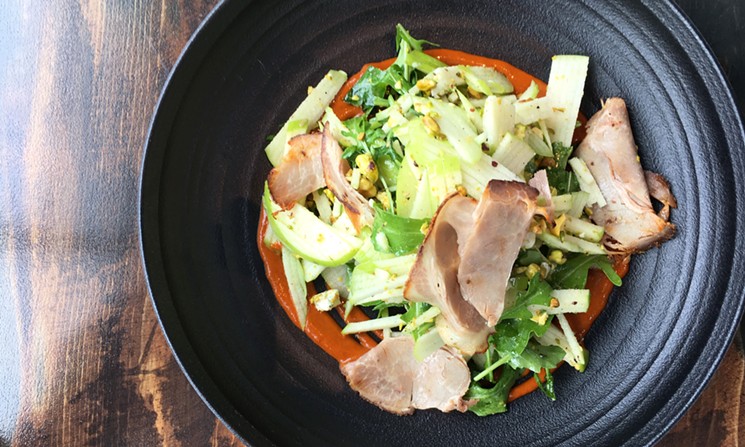 An apple salad with chef Nicolas Lebas's housemade tasso ham. - MARK ANTONATION
