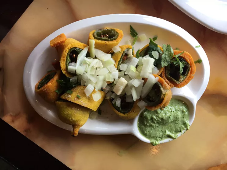 Cut mirchi resemble jalapeño poppers, but there's no cheese and the coating is made from chickpea flour. - MARK ANTONATION