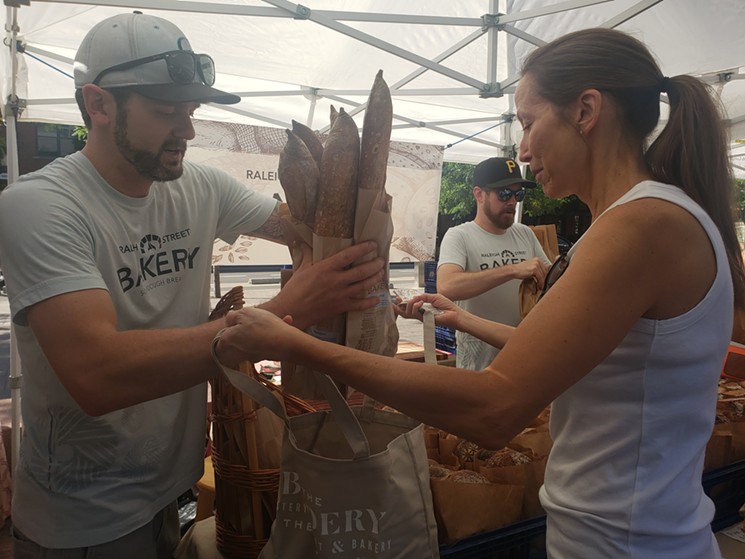 Chef Linda Hampsten Fox purchases baguettes from Raleigh Street Bakery at the Union Station Farmers' Market. - LINNEA COVINGTON