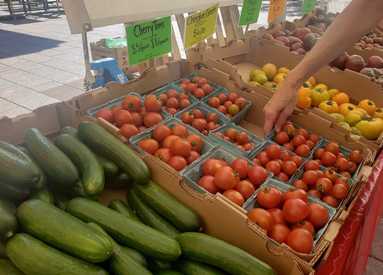 Rows of tomatoes and cucumbers at the Union Station Farmers' Market. - LINNEA COVINGTON