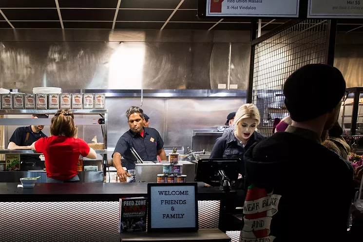 Chef Biju Thomas (center) in the kitchen at Biju's Little Curry Shop at Broadway Market. - DANIELLE LIRETTE