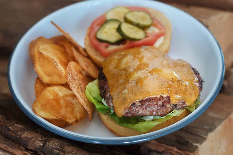 The Acreage Burger comes with housemade chips and is best paired with Piggy Bank, Off Dry, Rosé or Le Chêne. - ACREAGE