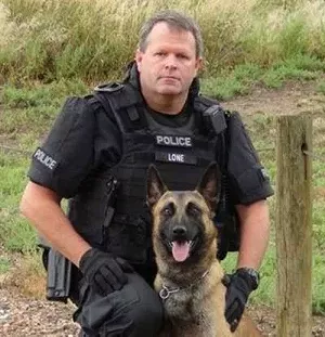 Lakewood Police Department Agent Patrick Lone seen posing with a different K-9 — not Finn. - LAKEWOOD POLICE DEPARTMENT VIA CBS4