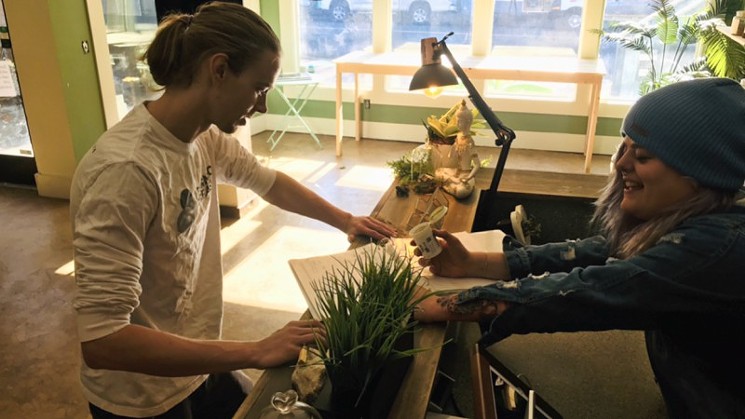 A customer makes a purchase at Clean Kratom Wellness Center. - COURTESY OF CLEAN KRATOM WELLNESS CENTER