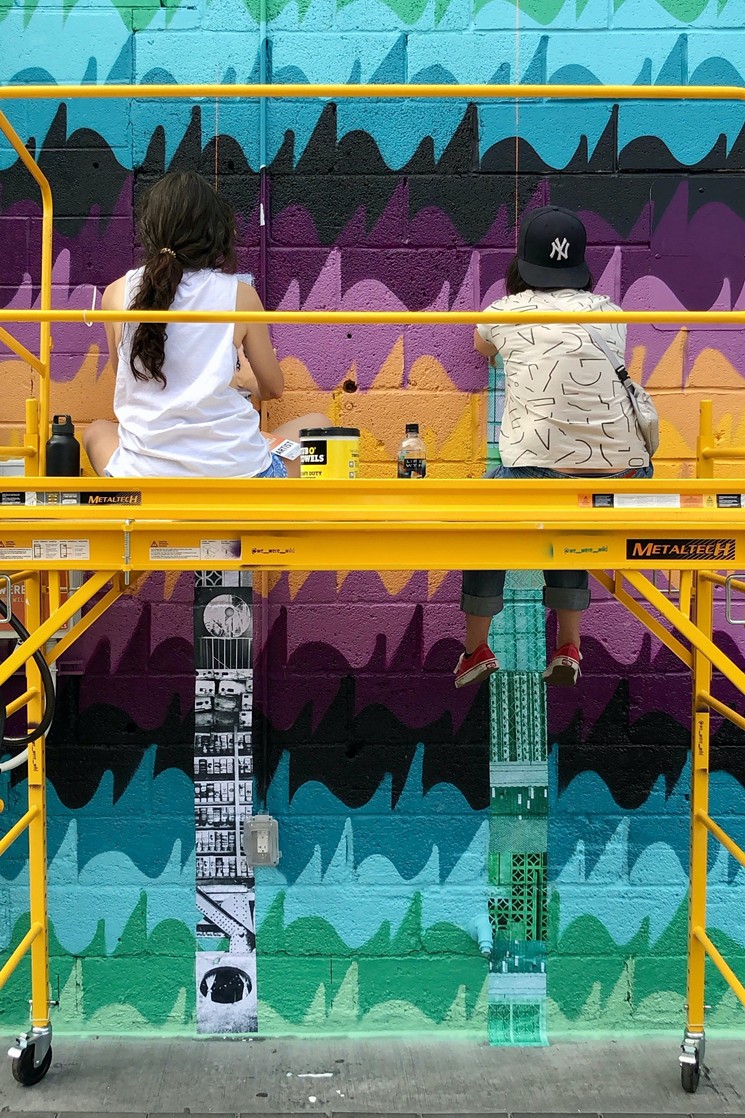 We Were Wild wheat-pasting photo prints and fabric to “Tight Knit,” their mural collaboration with Anthony Garcia, Sr. during Crush 2019. - JUSTIN SCHAFFER