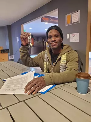 Frank Noble signs his first lease in ten years, after living in prison and then on the streets. - COURTESY OF HASSAN LATIF
