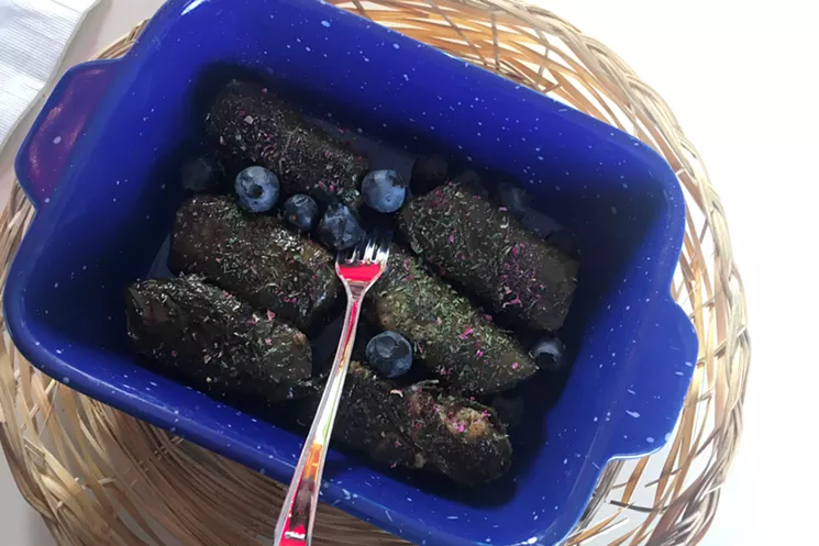 The stuffed grape leaves at Ladan's are dusted with rose petal and other herbs and accompanied by fresh fruit (blueberries, on this visit). - MARK ANTONATION