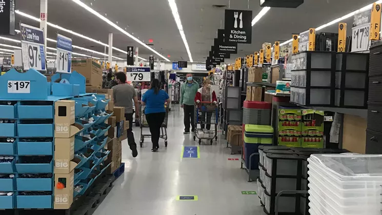 Inside the Walmart, floor stickers helped customers maintain proper social distancing. - PHOTO BY MICHAEL ROBERTS
