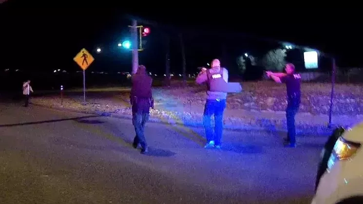 A screen capture showing three officers aiming their firearms at the late Nico Descheenie. - 18TH JUDICIAL DISTRICT