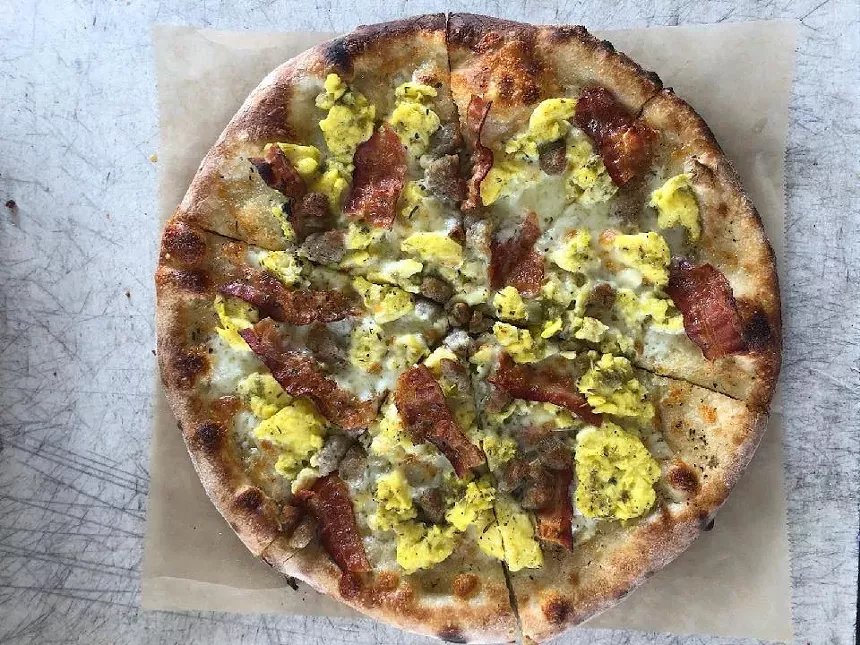 This green chile pie from Tilford's Pizza at Edgewater Public Market is topped with eggs, chiles and bacon or sausage. - COURTESY EDGEWATER PUBLIC MARKET