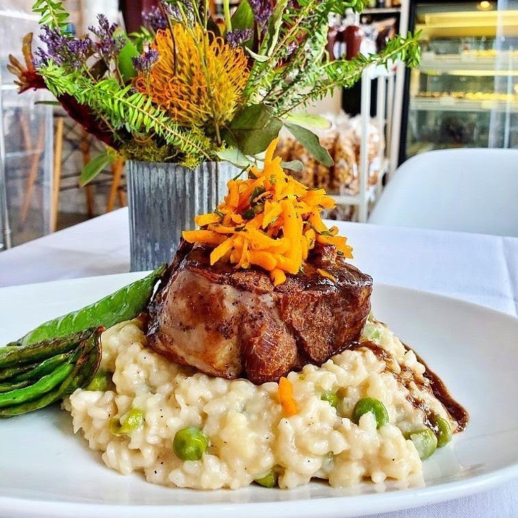 The Chocolate Lab's pork osso buco sits atop a mound of white chocolate and pea risotto. - COURTESY CHOCOLATE LAB