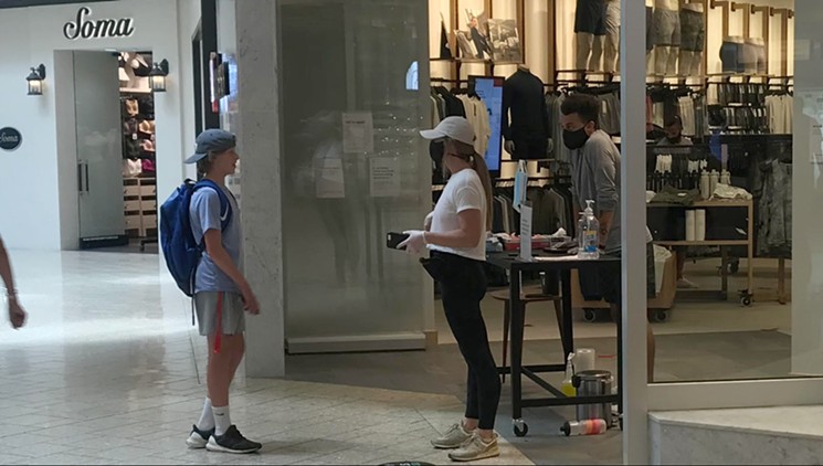 These Lululemon employees are explaining why they wouldn't admit an unmasked teen. - PHOTO BY MICHAEL ROBERTS