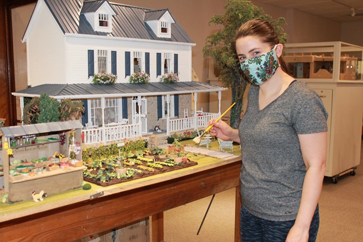 Littlepage touches up the farmhouse garden. - COURTESY OF THE DENVER MUSEUM OF MINIATURES, DOLLS AND TOYS