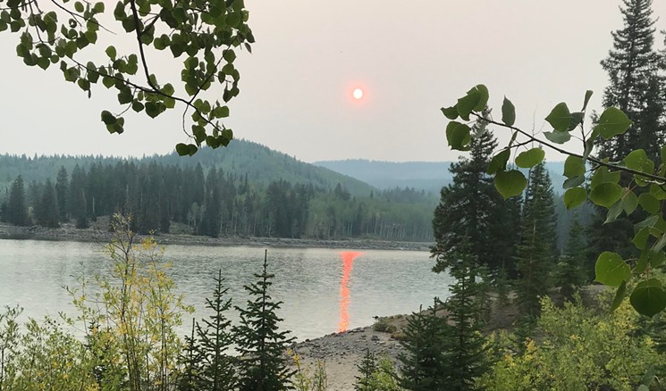 A lake on the Grand Mesa reflected a streak from the red sun early on Labor Day. - PHOTO BY MICHAEL ROBERTS