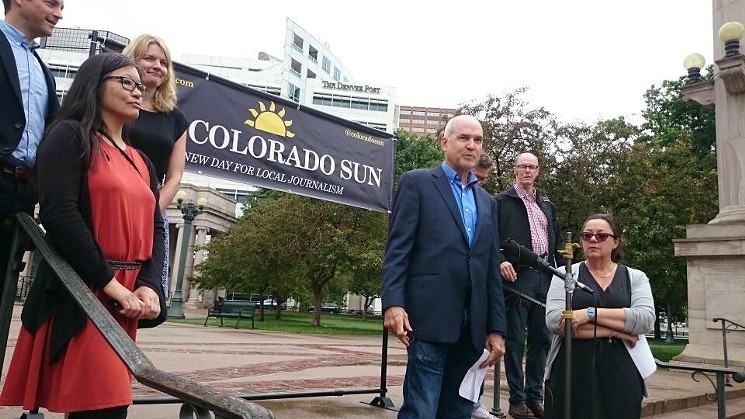 In June 2018, editor Larry Ryckman, center, and other members of the Colorado Sun staff announced the operation's launch in the shadow of the old Denver Post building. - PHOTO BY MICHAEL ROBERTS
