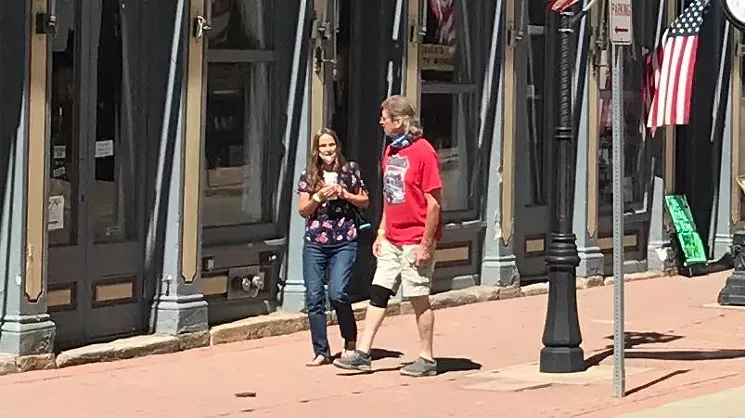 Most pedestrians in Central City left their masks down prior to entering businesses during our visit. - PHOTO BY MICHAEL ROBERTS