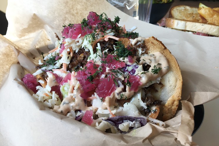 Rye Society's Jewish nachos are bagel chips loaded with pastrami, Swiss cheese, pickled red onions and Russian dressing. - MARK ANTONATION