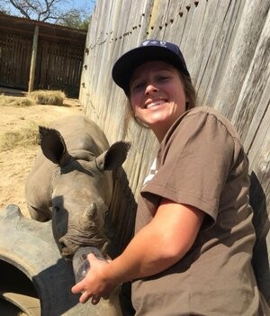 Kara Finklestein feeds an orphaned baby rhino while volunteering in 2017; her work was the inspiration for Lekker Cafe in RiNo. - COURTESY OF KARA FINKELSTEIN