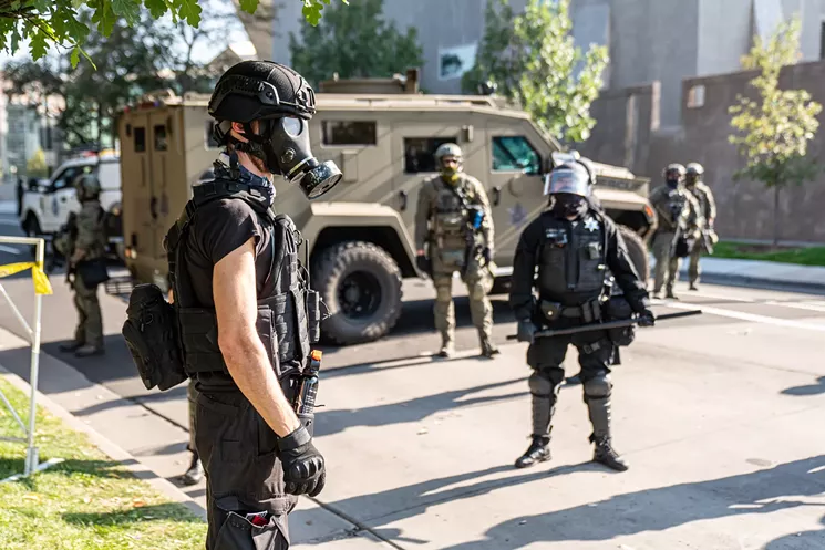 Denver police officers were present in force at the dueling demonstrations on October 10. - PHOTO BY MICHAEL EMERY HECKER
