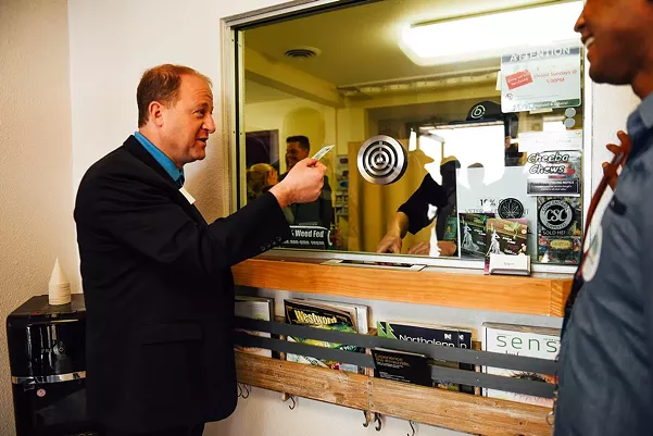 Colorado Governor Jared Polis, seen here visiting a dispensary, has issued numerous executive orders related to marijuana during the COVID-19 pandemic. - KENZIE BRUCE