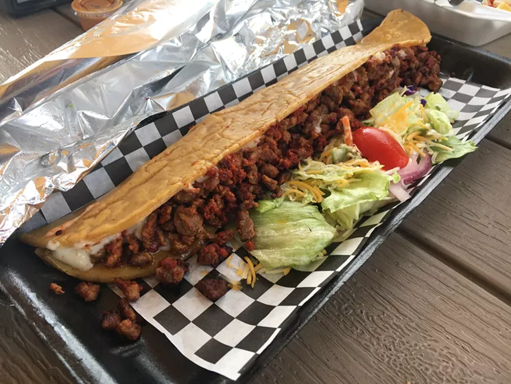This extra-long taco is a machete from Tacos y Machetes La Carpa, a regular at La Esquina Del Sabor. - MARK ANTONATION