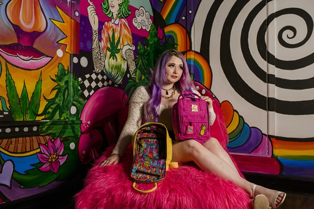 Ellie Paisley poses with her new backpacks inside the room she painted in Denver's Marijuana Mansion. - LILLIE ELLIOT PHOTOGRAPHY