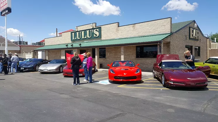 cars parked in front of a brick building